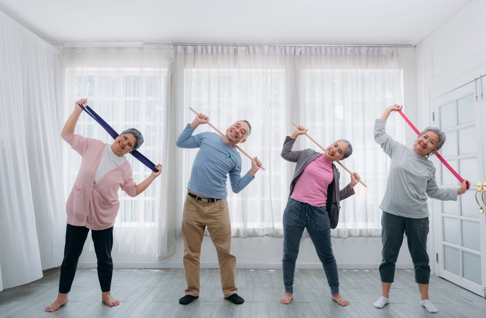 Seniors doing group fitness workout at home with a personal trainer
