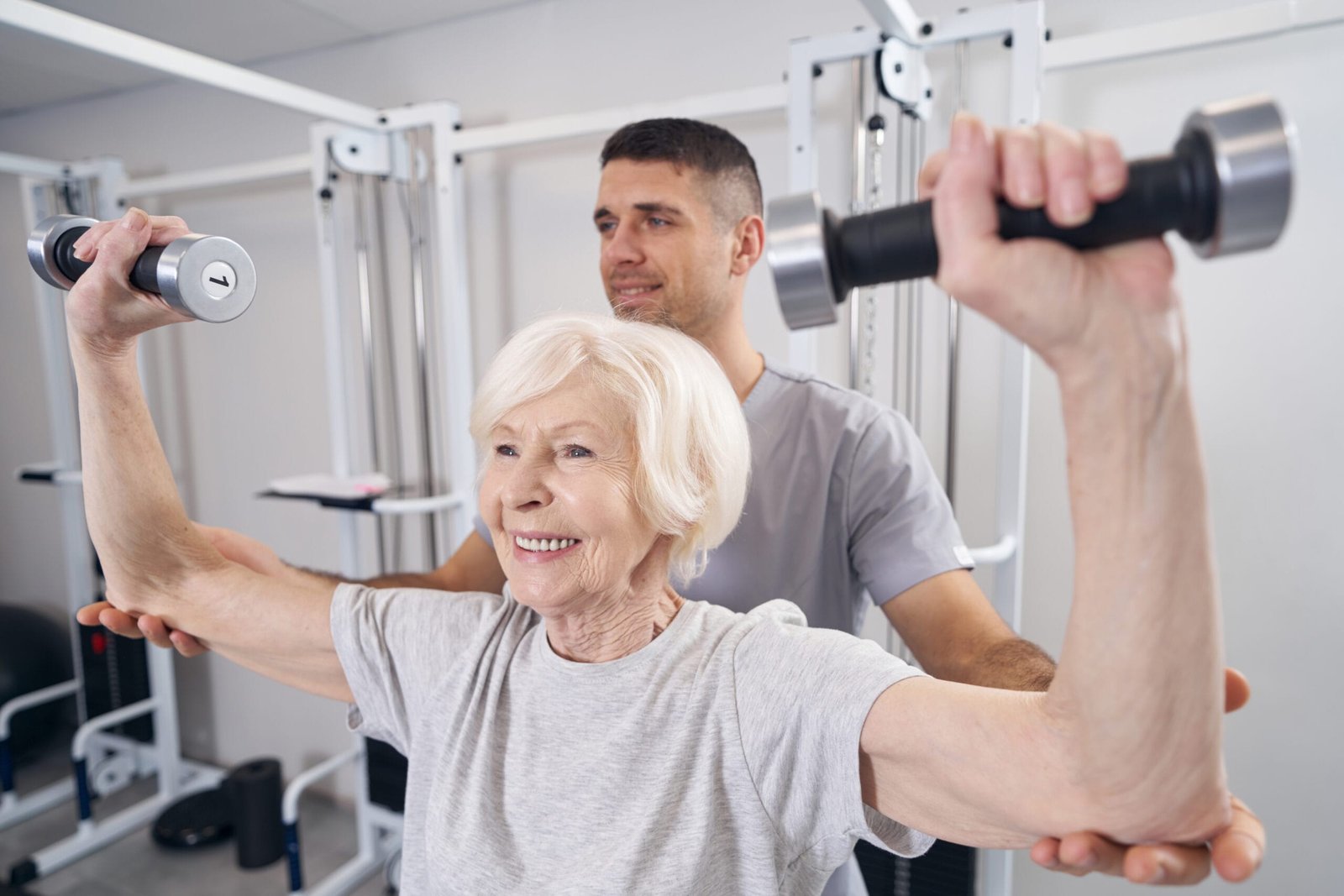 Certified personal trainer helping senior client at home in Etobicoke