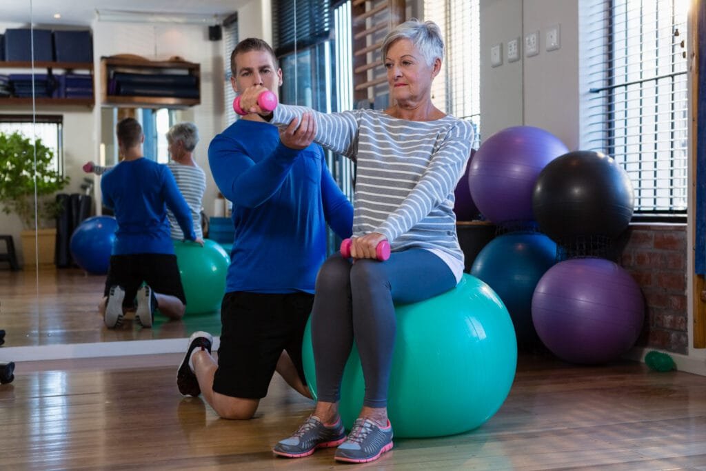 physiotherapist assisting senior woman on exercise 2023 11 27 05 10 41 utc 2