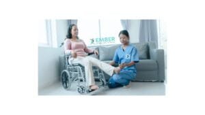 Senior man performing seated leg extensions at home with guidance from a personal trainer