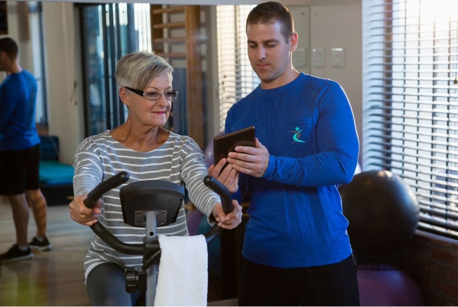 Certified in-home personal trainer guiding a client through a workout session at home