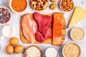 A variety of protein-rich foods including fish, chicken, beef, eggs, dairy, nuts, and grains