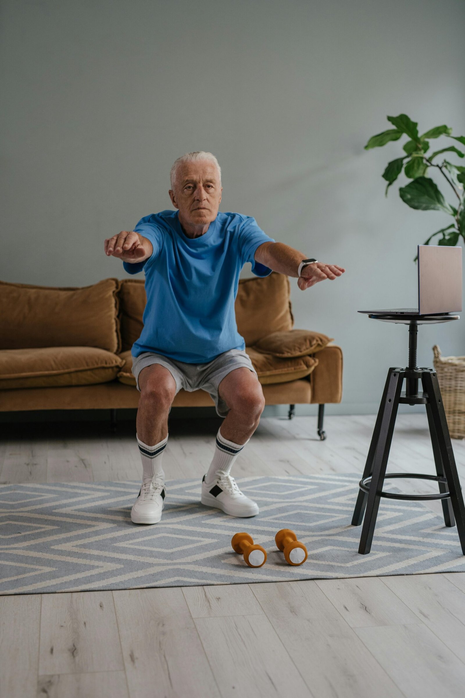 Senior woman practicing balance and mobility exercises with trainer in Oakville living room
